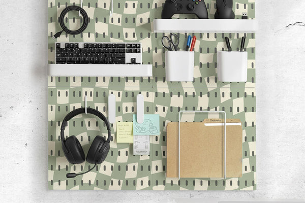 Black and white checkered pegboard wall organizer with panels, containers, shelves, clips, hooks, and a letter holder.