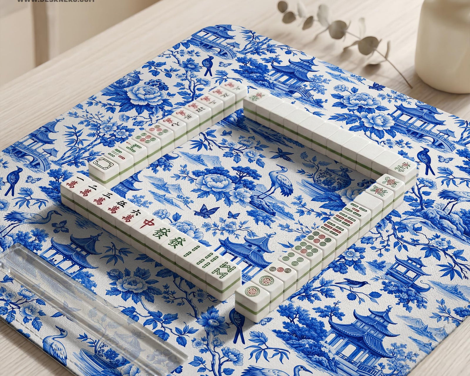 Blue mahjong mat with an Asian garden landscape pattern showing pagodas, birds, and flowers.