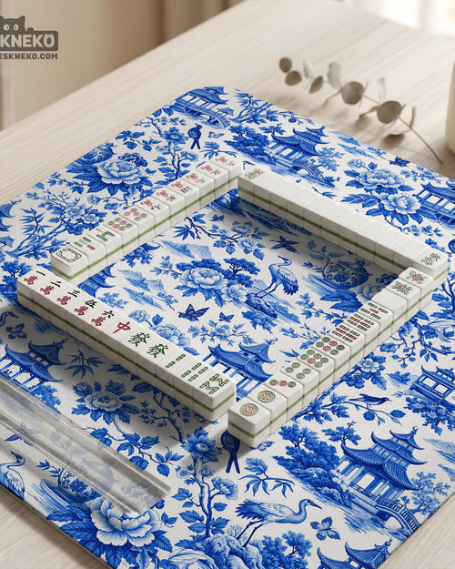 Blue mahjong mat with an Asian garden landscape pattern showing pagodas, birds, and flowers.