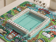 Mint green mahjong mat with a cat garden border, koi fish, bamboo, blossoms, and scenic details around an open center.