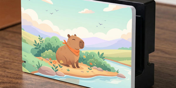 A pastel Switch case with a smiling capybara, green hills, a river, and a soft muted sky.