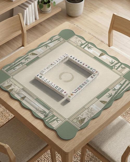 Sage green mahjong mat with a bamboo design and a light center area, shown as a square tabletop game mat.