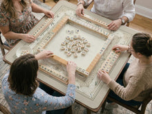 Square mahjong mat with a bamboo and geometric pattern in cream, beige, and sage tones.