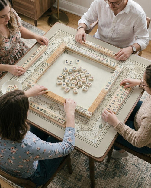 Square mahjong mat with a bamboo and geometric pattern in cream, beige, and sage tones.
