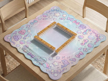 Mahjong mat with a light blue, pink, and lavender border showing shells, bows, bubbles, dolphins, and seahorses around an open center.