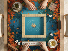 Square mahjong table mat with an autumn pond design, orange maple leaves around the border, and blue water with leaf and ripple details.