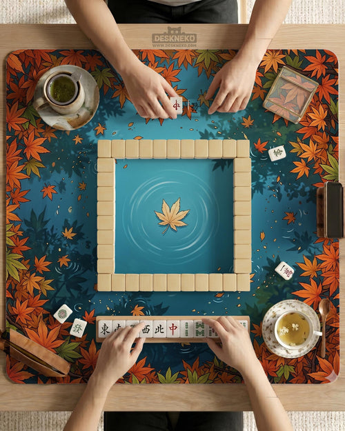 Square mahjong table mat with an autumn pond design, orange maple leaves around the border, and blue water with leaf and ripple details.