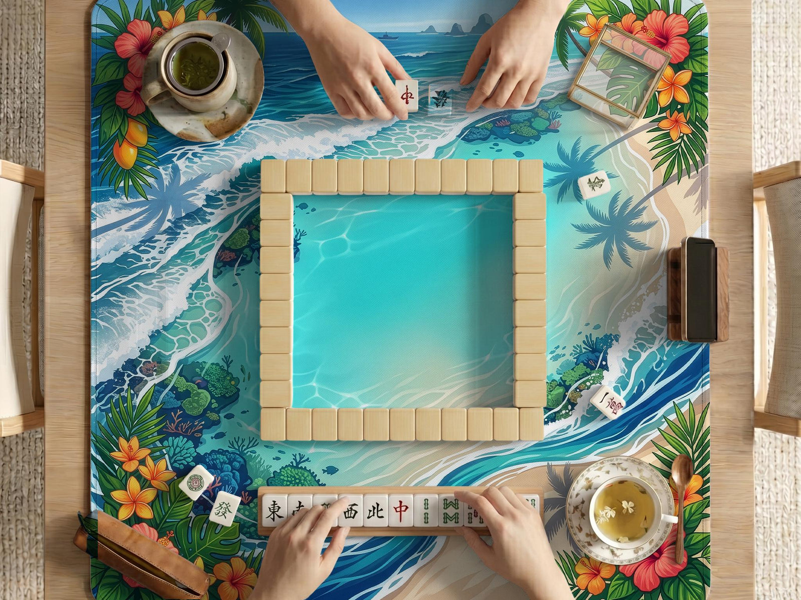 Mahjong table mat with a tropical island shoreline design, blue lagoon water, ocean waves, coral accents, palm leaves, and hibiscus flowers around the edges.