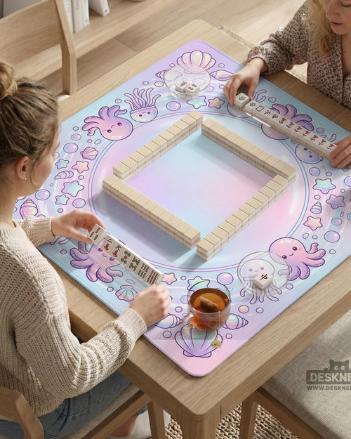 A square mahjong table mat with pastel jellyfish, stars, shells, and bubble details around the border and an open center.