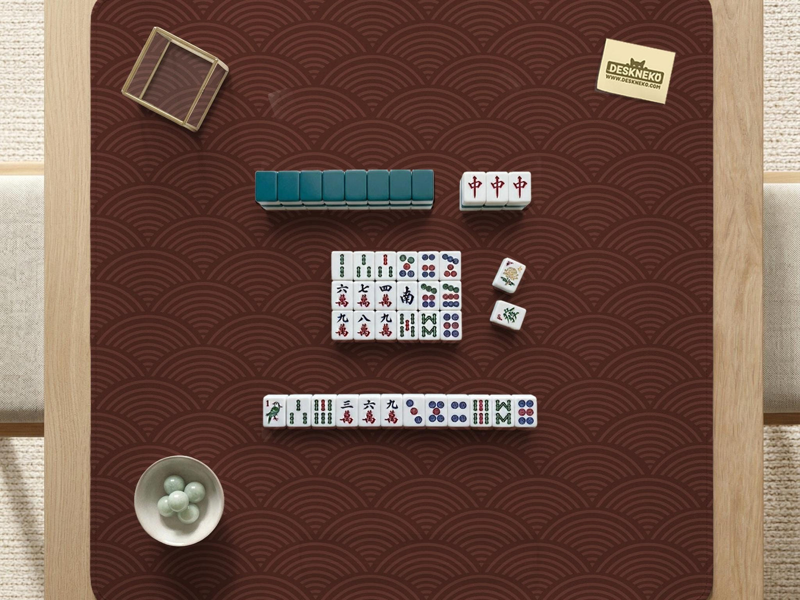 Square brown mahjong mat with a repeating seigaiha wave pattern in a decorative Japanese-style design.