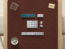Square brown mahjong mat with a repeating seigaiha wave pattern in a decorative Japanese-style design.