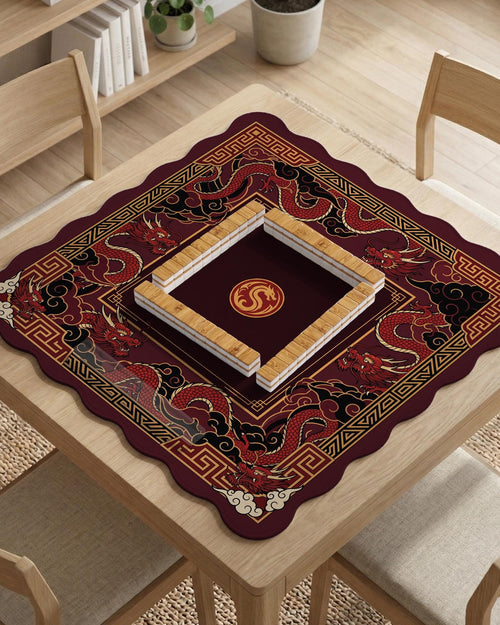 A square mahjong table mat with a red, black, and gold dragon design and an open center area.