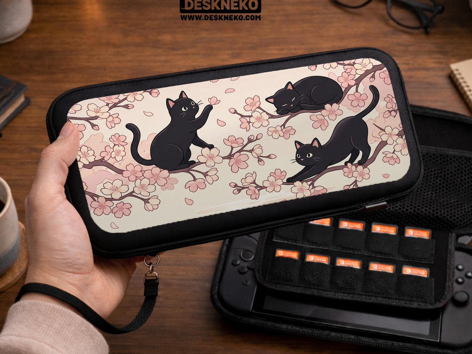 Switch case with black cats and cherry blossoms on a light pastel background.