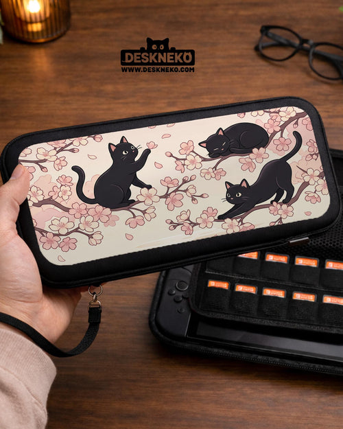 Switch case with black cats and cherry blossoms on a light pastel background.