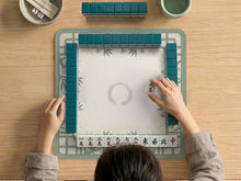 Square sage green mahjong mat with a bamboo and floral border and an open center.