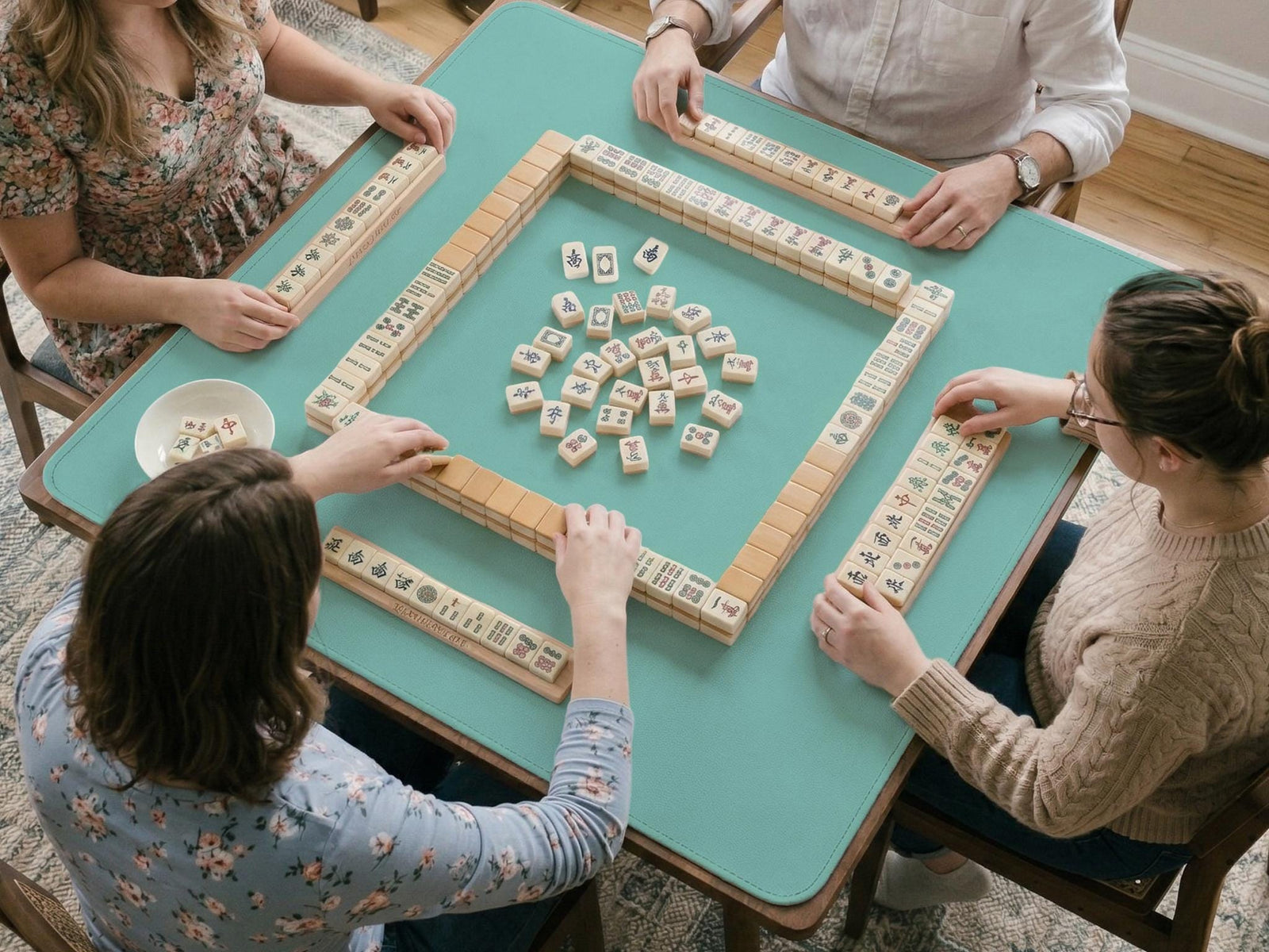 Solid turquoise square mahjong table mat with a scalloped edge.