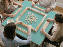 Solid turquoise square mahjong table mat with a scalloped edge.