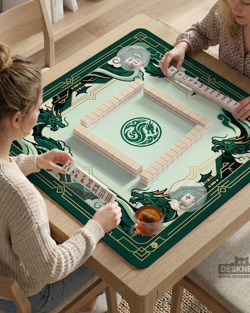 A square mahjong table mat with an emerald green dragon border, jade green center, cream details, and gold art deco accents.