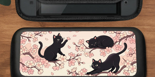Pink Switch carrying case with a cherry blossom and black cat print on the front.