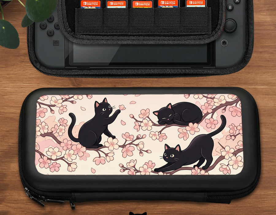 Pink Switch carrying case with a cherry blossom and black cat print on the front.
