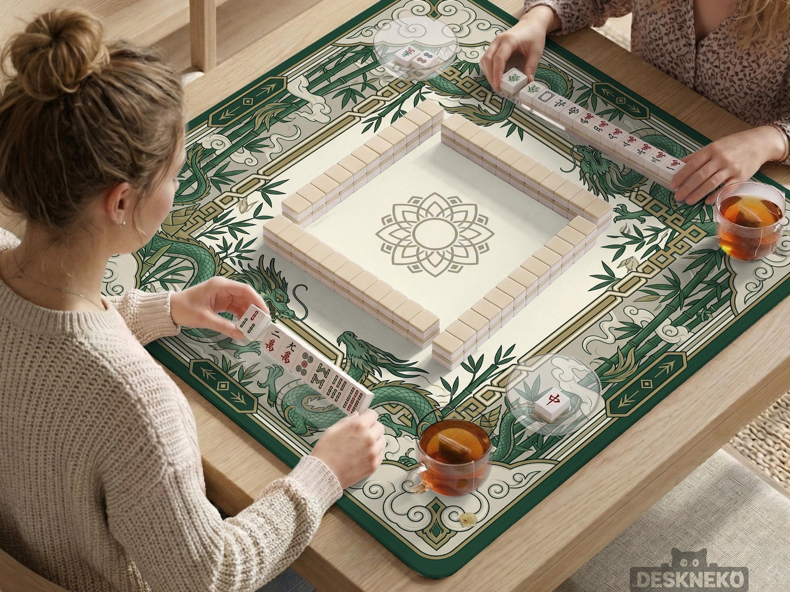 Square mahjong mat with a cream center and a border featuring emerald green dragons, bamboo stalks, cloud shapes, and geometric details.
