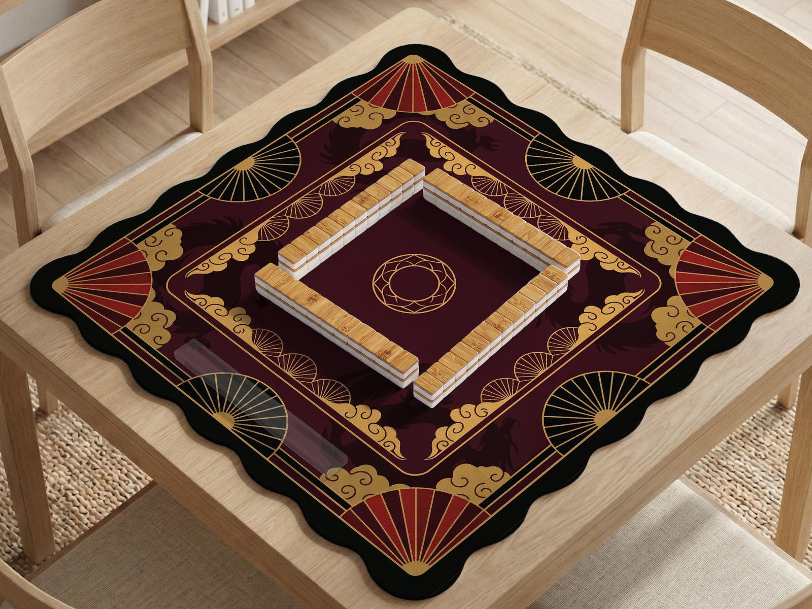 Square mahjong mat with red, black, and gold dragon silhouettes, cloud motifs, and decorative fan-like shapes.