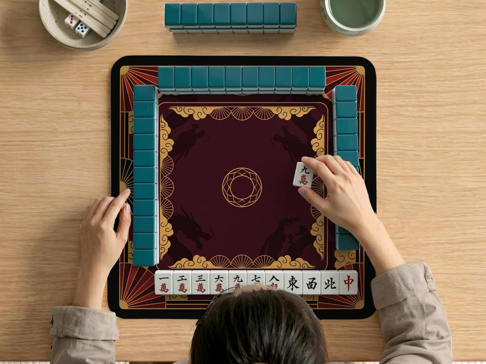 Square mahjong mat with a red, black, and gold dragon design and a dark background.