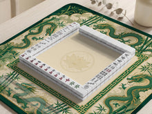 Green mahjong mat with dragon and bamboo artwork and a clean open center.