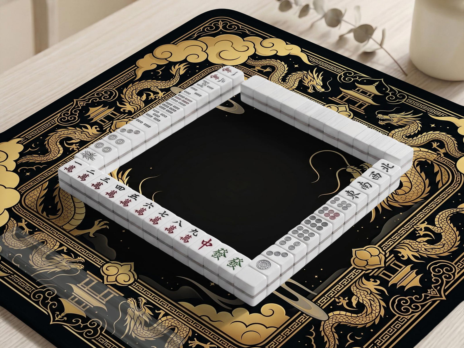 Black and gold mahjong mat with a dragon border, ornate cloud details, and a dark center area.