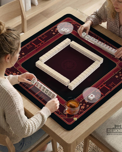 Square burgundy mahjong mat with a cherry blossom floral border and a dark open center.