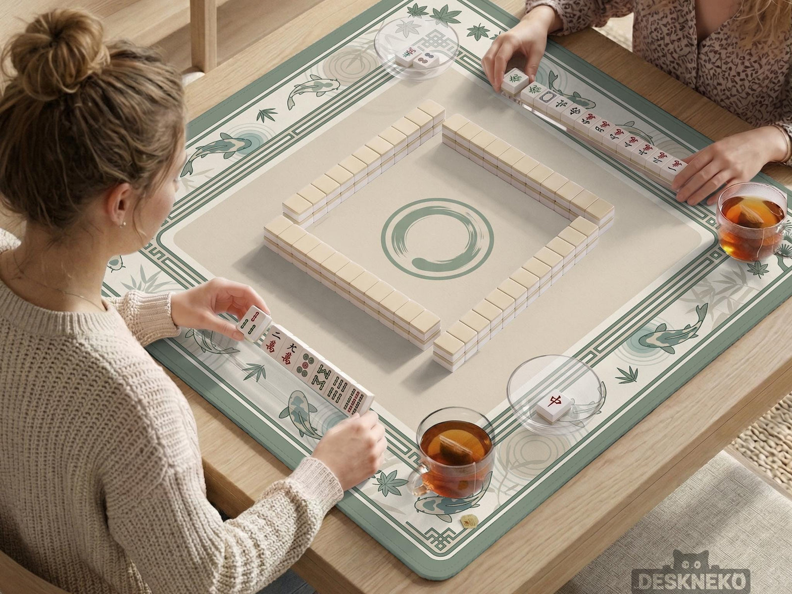 A square sage green mahjong table mat with koi fish, bamboo accents, and a bordered play area.