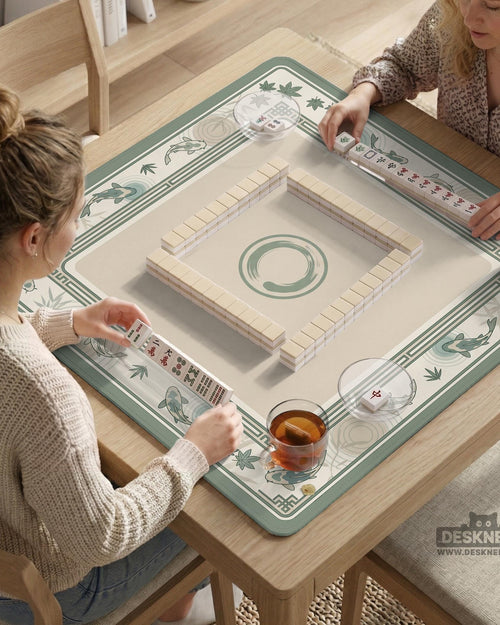 A square sage green mahjong table mat with koi fish, bamboo accents, and a bordered play area.