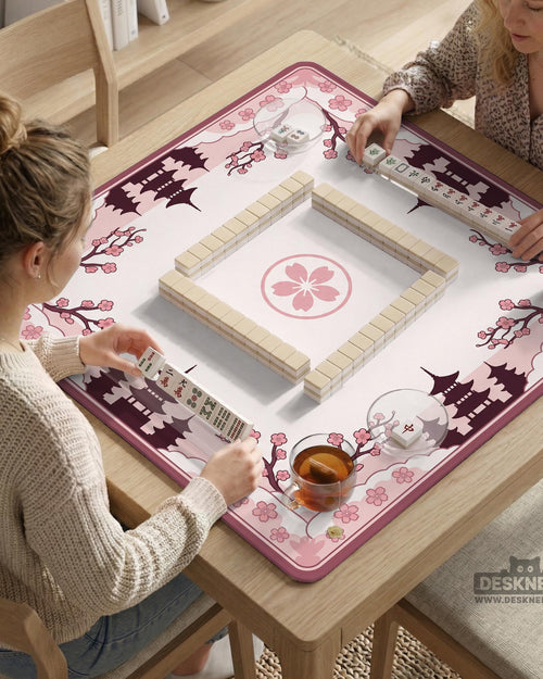 Pink mahjong table mat with cherry blossom and pagoda artwork around the border and an open center.