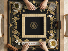 Black and gold mahjong table mat with a crane design, floral Art Deco details, and a wide border around an open center area.