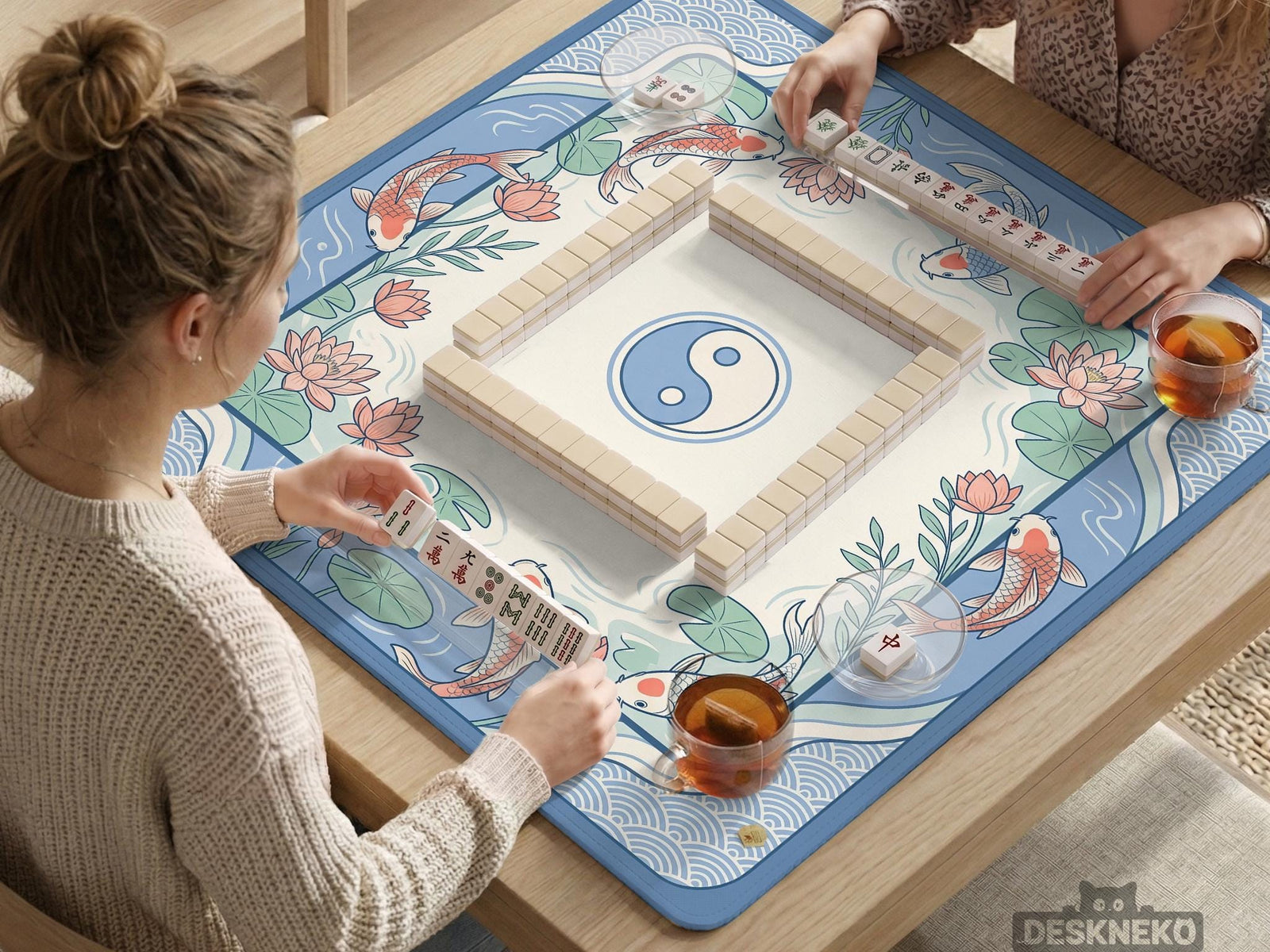 Blue mahjong mat with koi fish, lotus flowers, and an open center design in a water garden style.