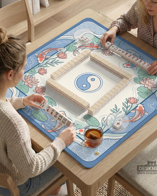 Blue mahjong mat with koi fish, lotus flowers, and an open center design in a water garden style.
