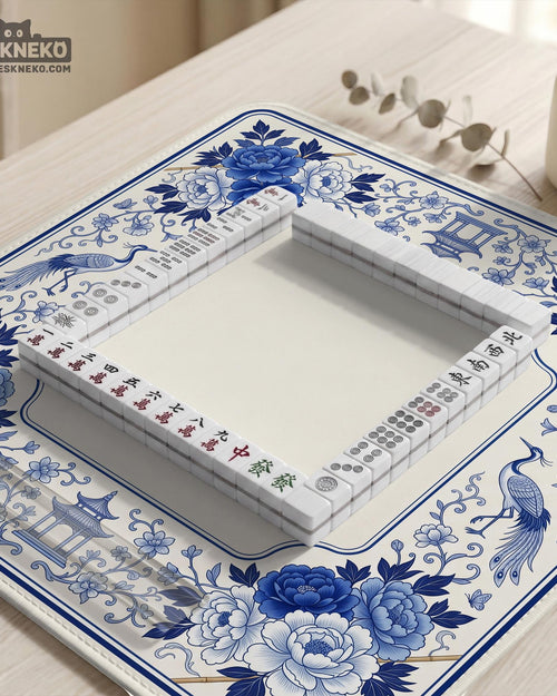 Square blue and white mahjong mat with peonies, cranes, pagoda accents, and chinoiserie linework around a plain center.