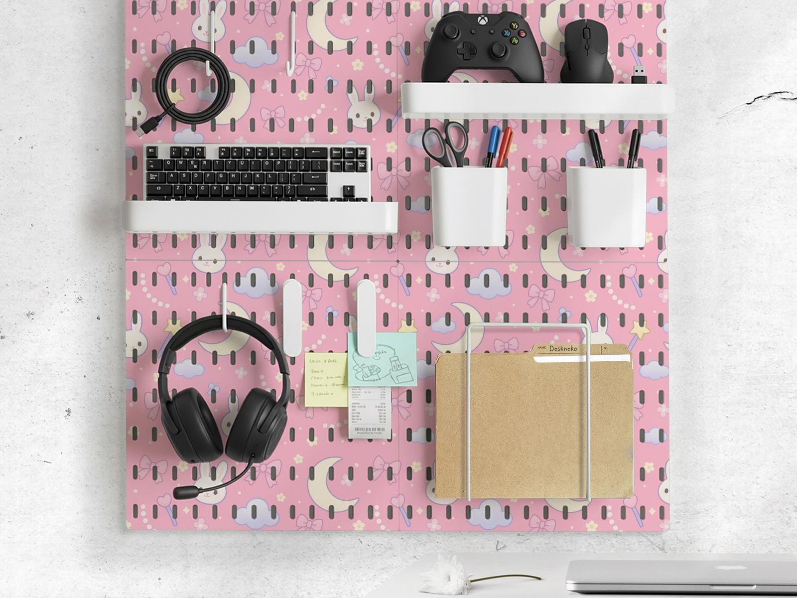 Pink pegboard panels with bunny, moon, cloud, bow, star, and small flower designs, shown as a wall organizer set with containers, shelves, clips, hooks, and a letter holder.
