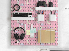 Pink pegboard panels with bunny, moon, cloud, bow, star, and small flower designs, shown as a wall organizer set with containers, shelves, clips, hooks, and a letter holder.