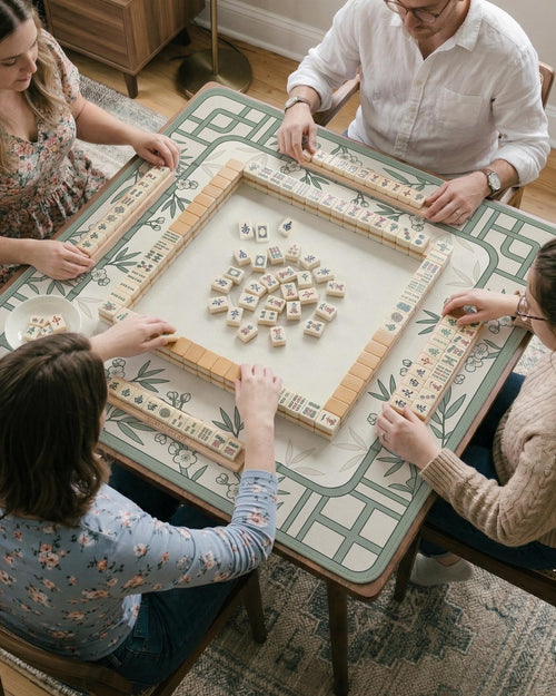Square mahjong mat with a sage green bamboo floral line design, cream background, and rounded border.