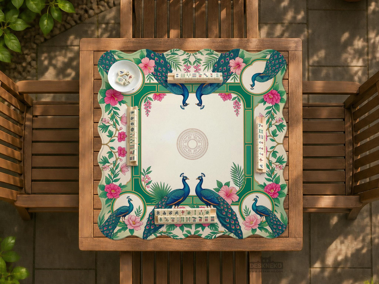 Green mahjong mat with peacocks, hibiscus flowers, tropical leaves, cream center space, and a scalloped floral border.
