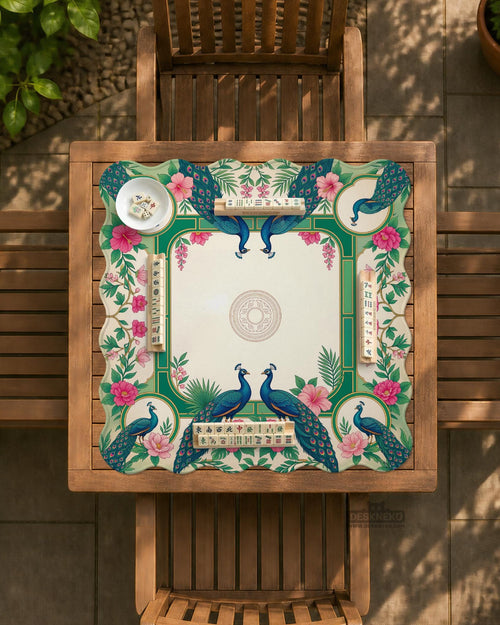 Green mahjong mat with peacocks, hibiscus flowers, tropical leaves, cream center space, and a scalloped floral border.