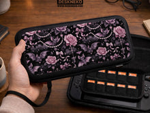 A black Switch carrying case with a pink gothic rose print, small bats, ribbon bows, pearl chain details, and tiny sparkles.