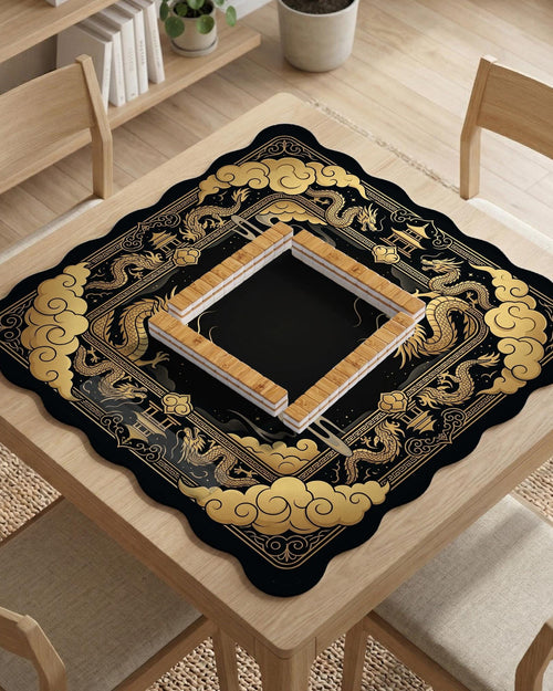 Black and gold mahjong table mat with a scalloped edge, dragon artwork around the border, cloud details, and a clean center area.