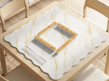 White marble mahjong mat with gold veining and a scalloped decorative edge.
