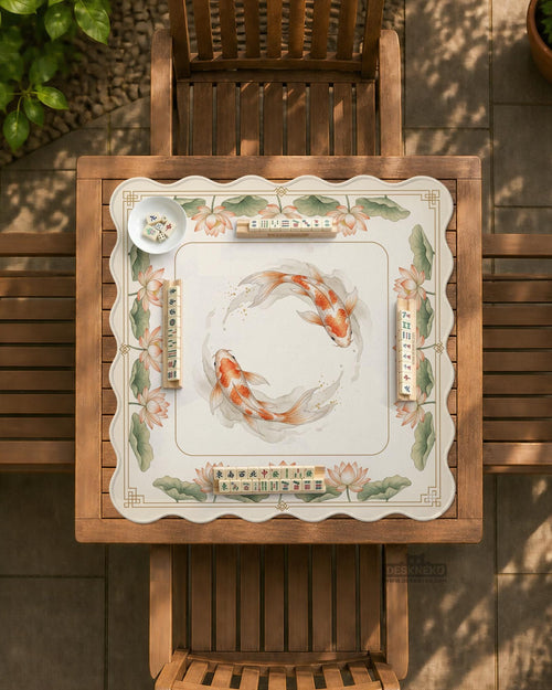 A cream mahjong mat with orange koi fish, sage lotus leaves, and a thin gold border.