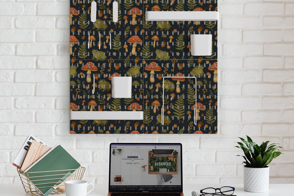 Four charcoal pegboard panels with mushrooms, frogs, leaves, and acorns, arranged as a wall organizer with hooks, shelves, containers, clips, and holders.