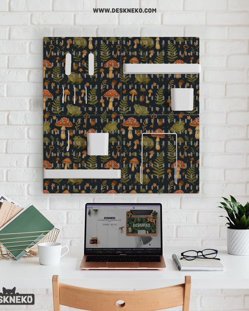 Four charcoal pegboard panels with mushrooms, frogs, leaves, and acorns, arranged as a wall organizer with hooks, shelves, containers, clips, and holders.