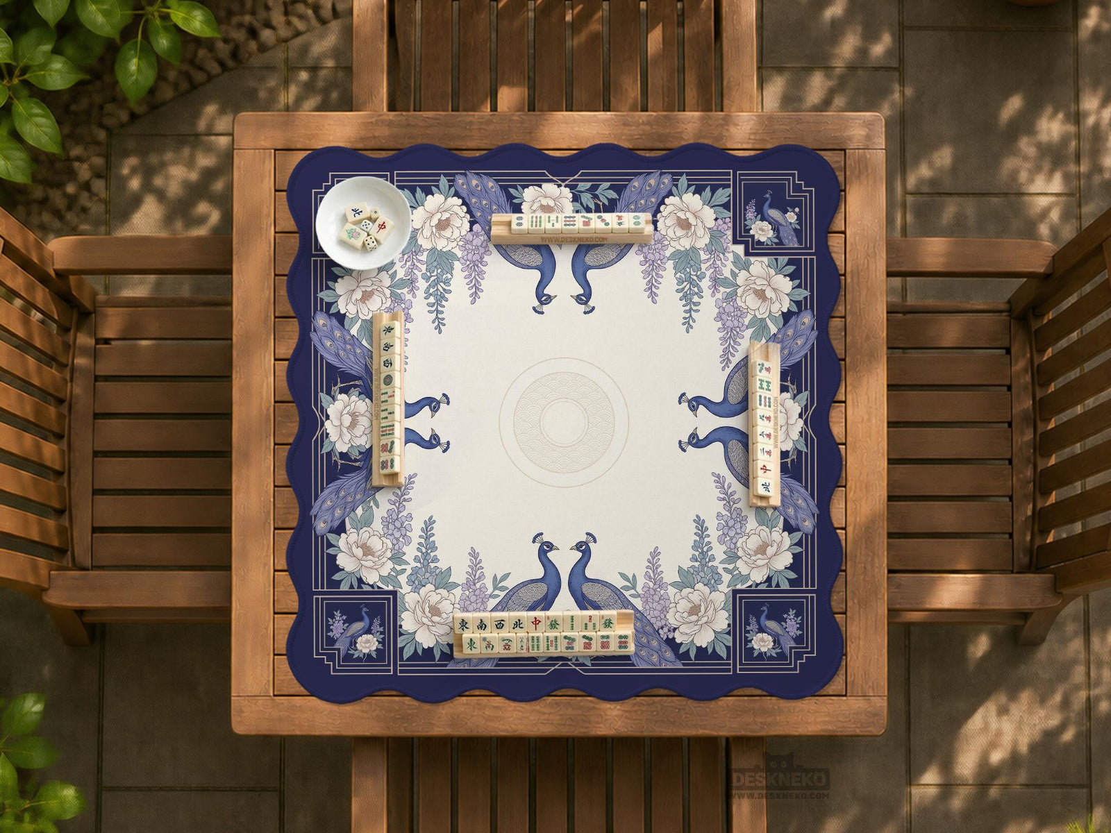Blue mahjong table mat with a peacock and floral border, ivory center, lavender flowers, and scalloped edges.
