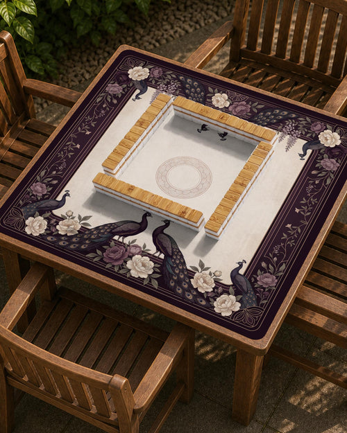 Square mahjong mat with a dark plum border, ivory floral pattern, muted sage leaves, and a decorative peacock garden design.